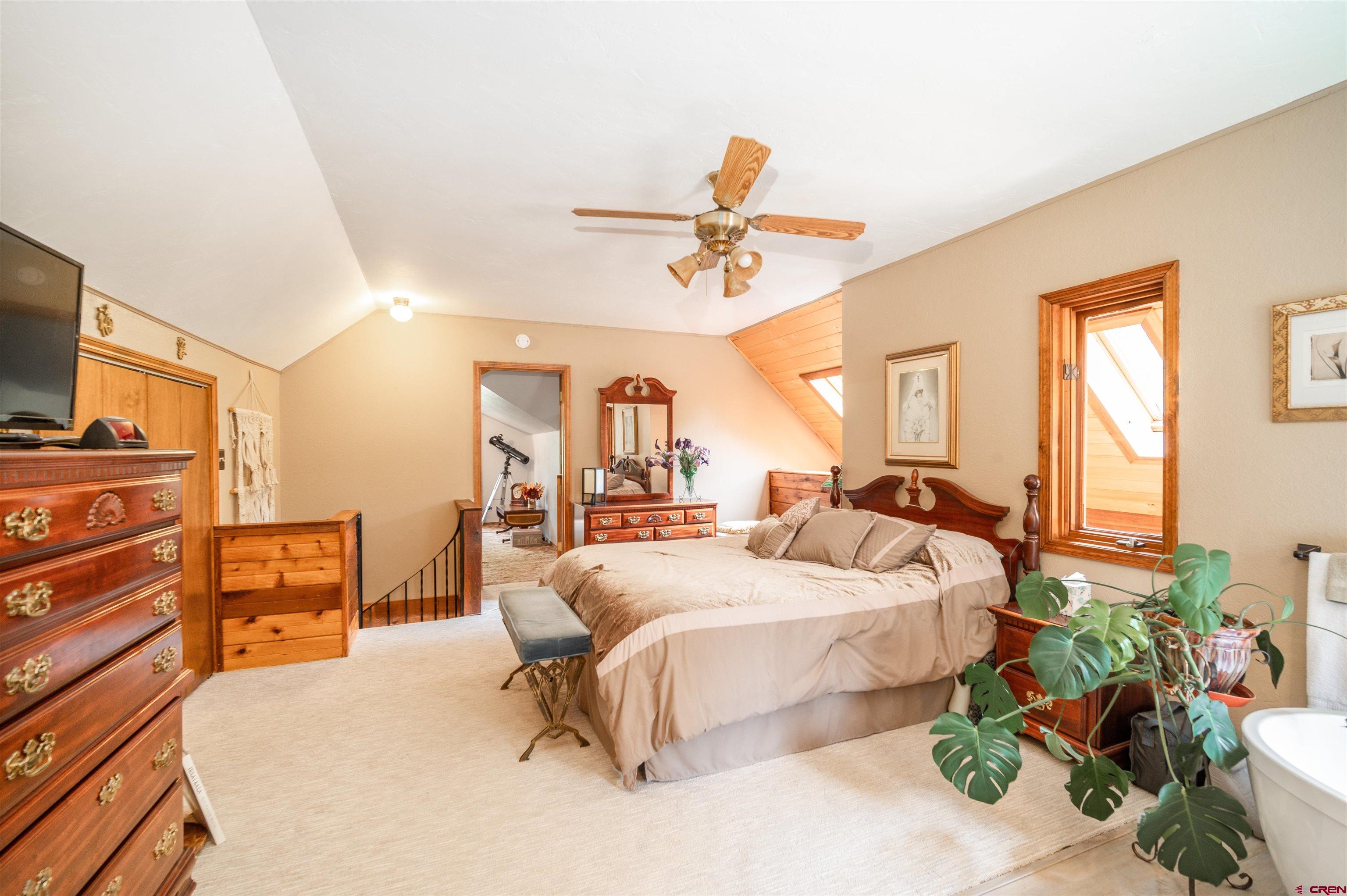 520 Los Ranchitos Drive Durango, CO 81301 - Photo 21 of 36 a bedroom with a bed and ceiling fan