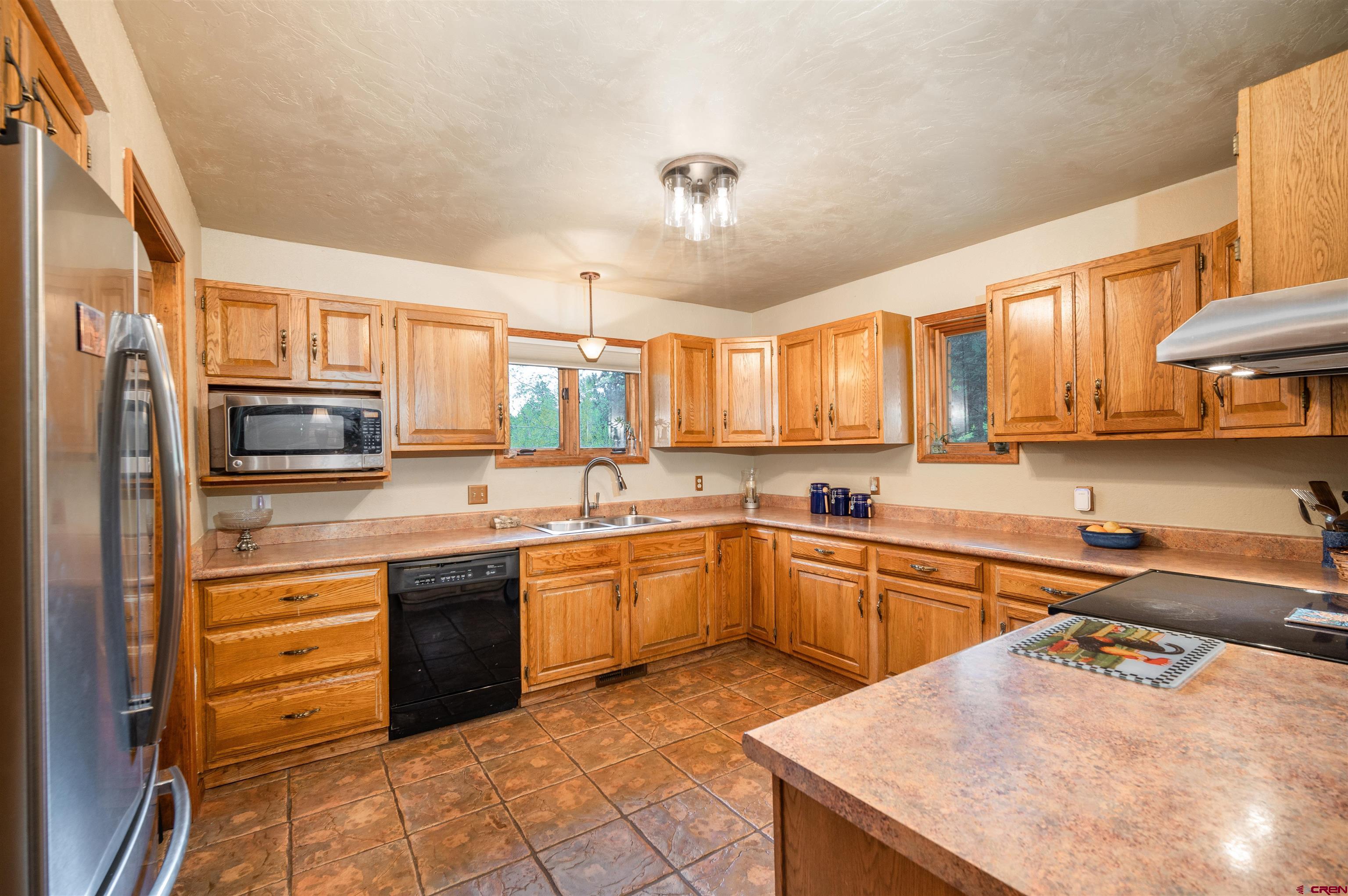 520 Los Ranchitos Drive Durango, CO 81301 - Photo 7 of 36 a kitchen with stainless steel appliances granite countertop a sink dishwasher stove and refrigerator