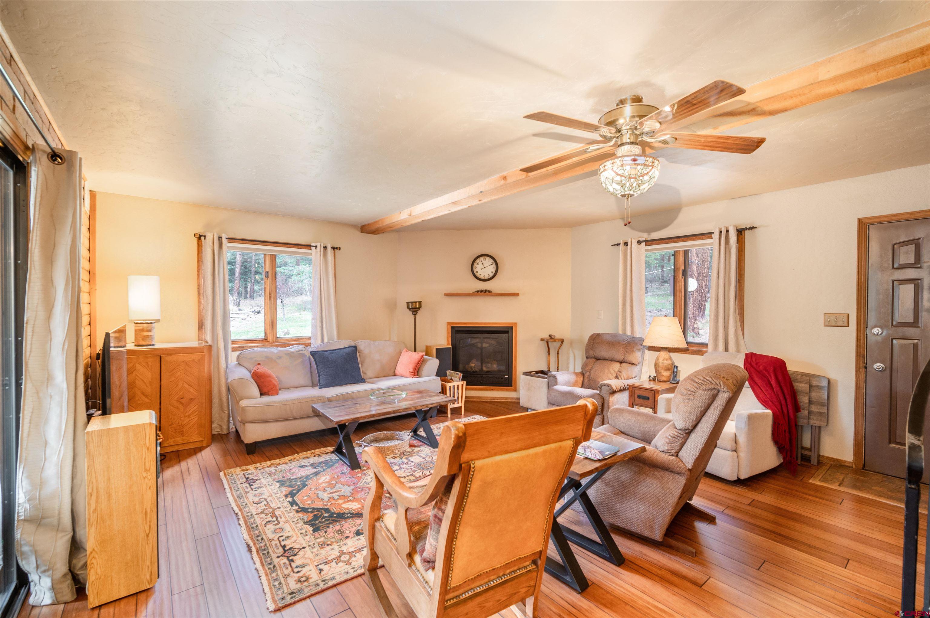 520 Los Ranchitos Drive Durango, CO 81301 - Photo 10 of 36 a living room with furniture a fireplace and a flat screen tv