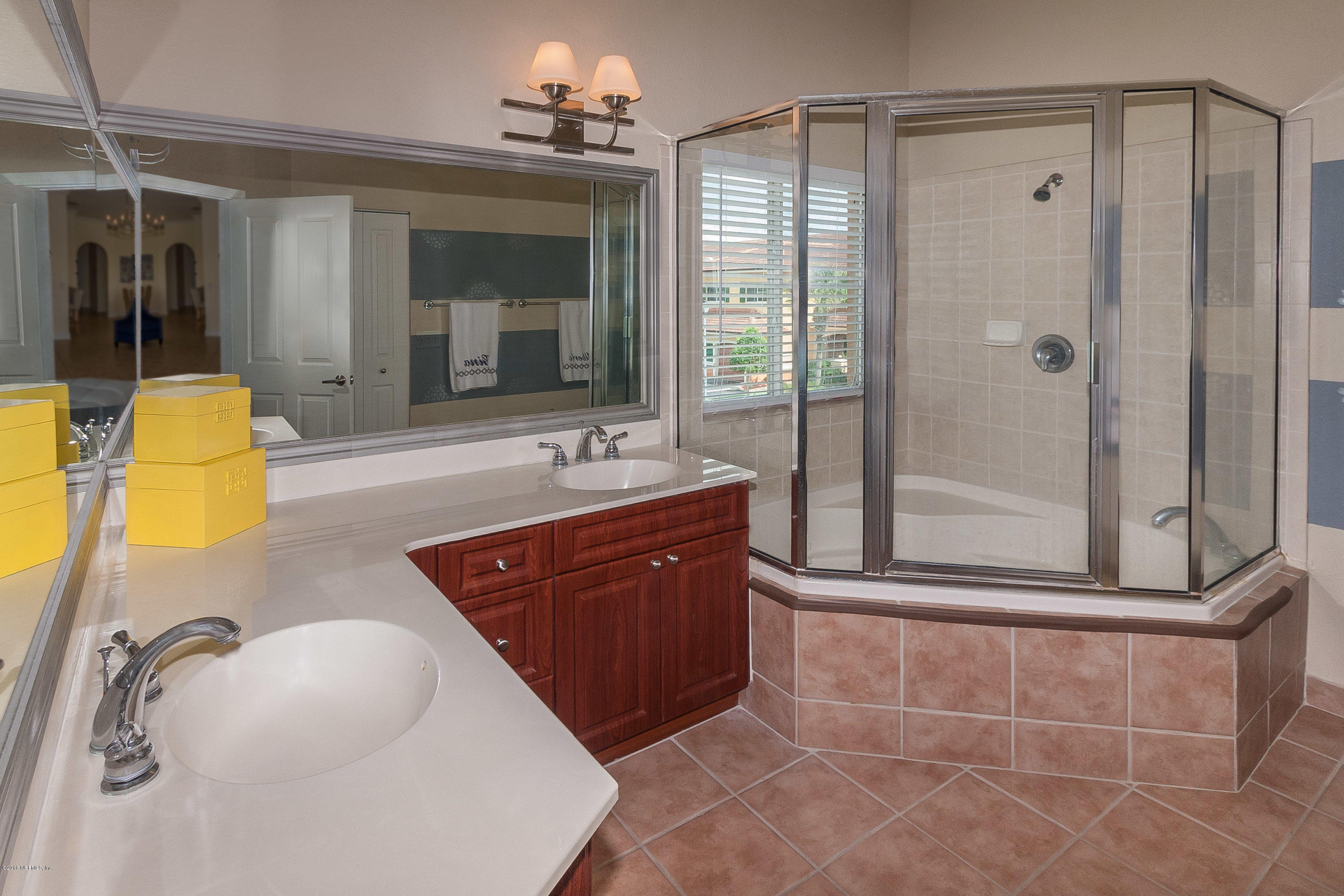 9745 Touchton Road, Unit 2521 Jacksonville, FL 32246 - Photo 12 of 31 a bathroom with a tub sink and mirror