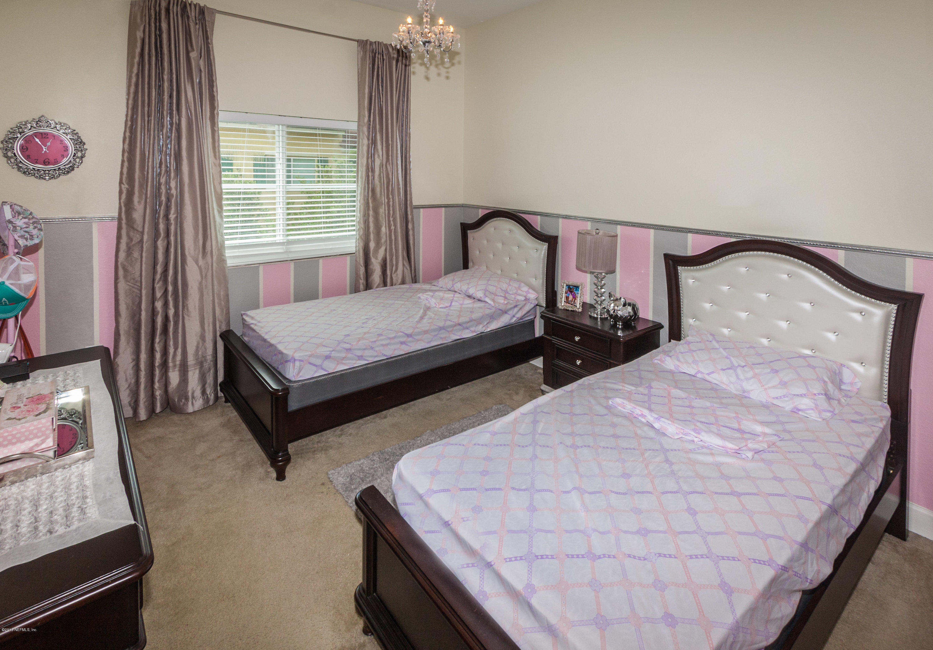 9745 Touchton Road, Unit 2521 Jacksonville, FL 32246 - Photo 13 of 31 a bedroom with two beds and window