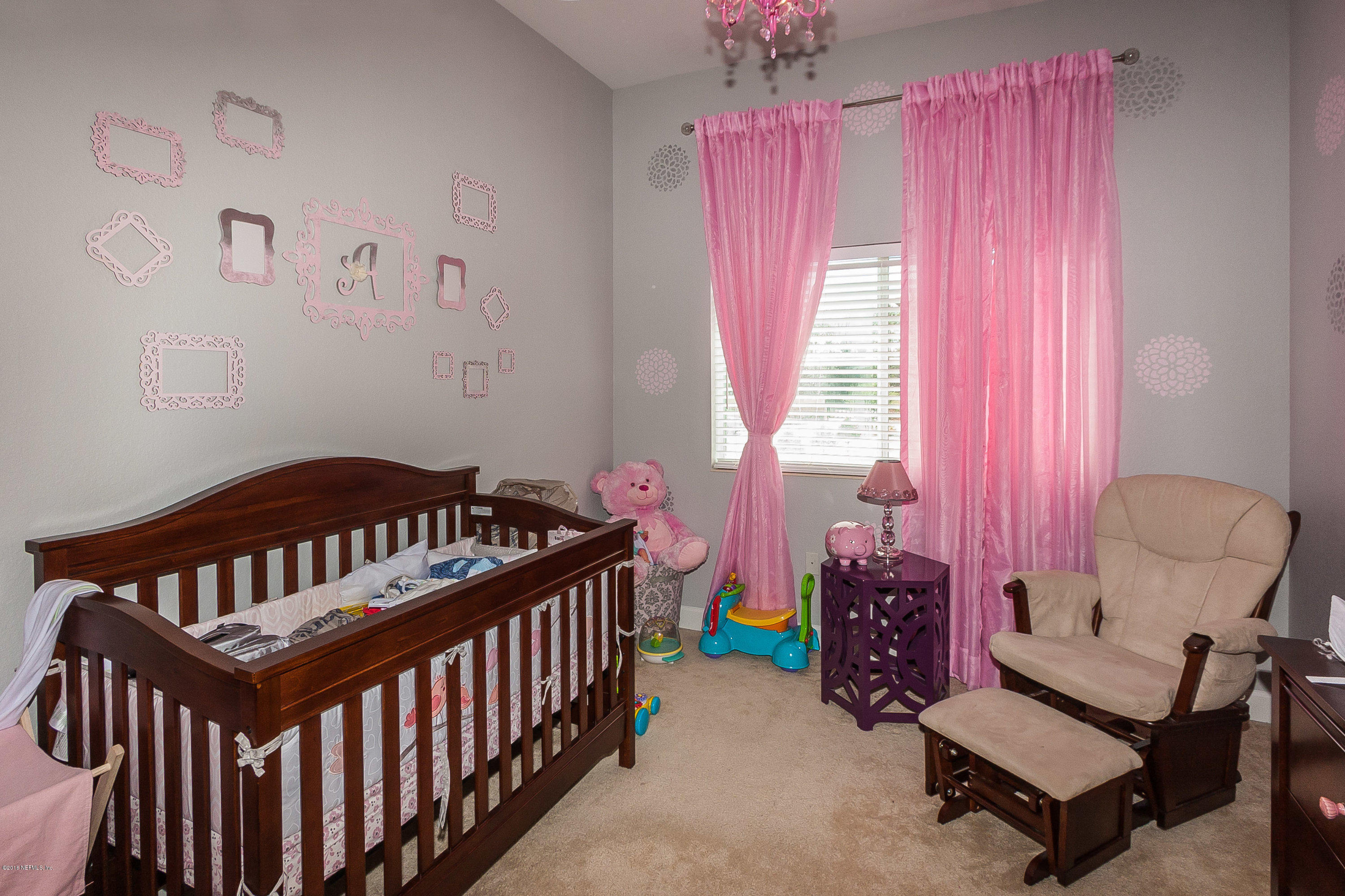 9745 Touchton Road, Unit 2521 Jacksonville, FL 32246 - Photo 14 of 31 a bedroom with furniture and a chandelier