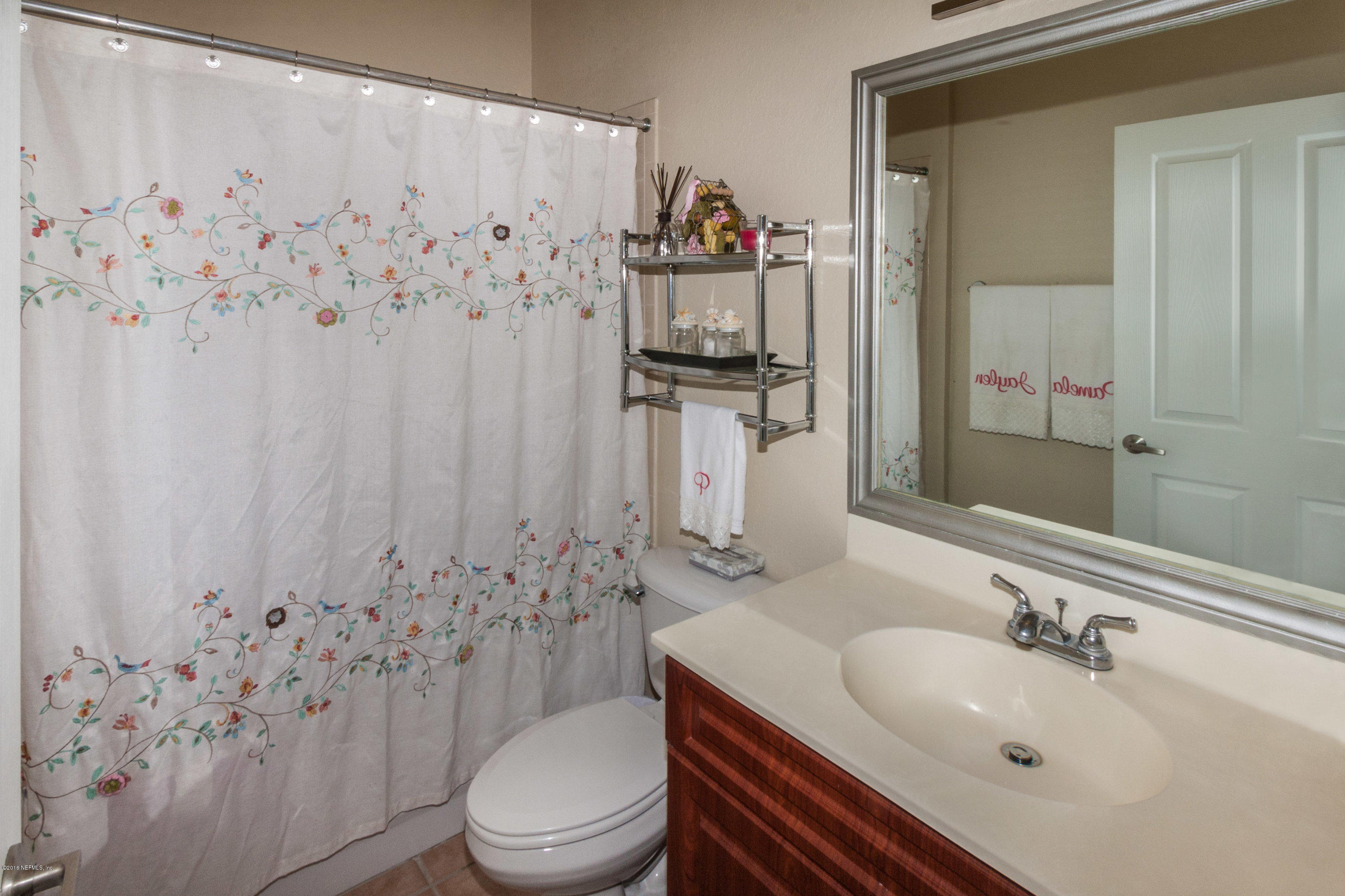 9745 Touchton Road, Unit 2521 Jacksonville, FL 32246 - Photo 15 of 31 a bathroom with a sink toilet and shower