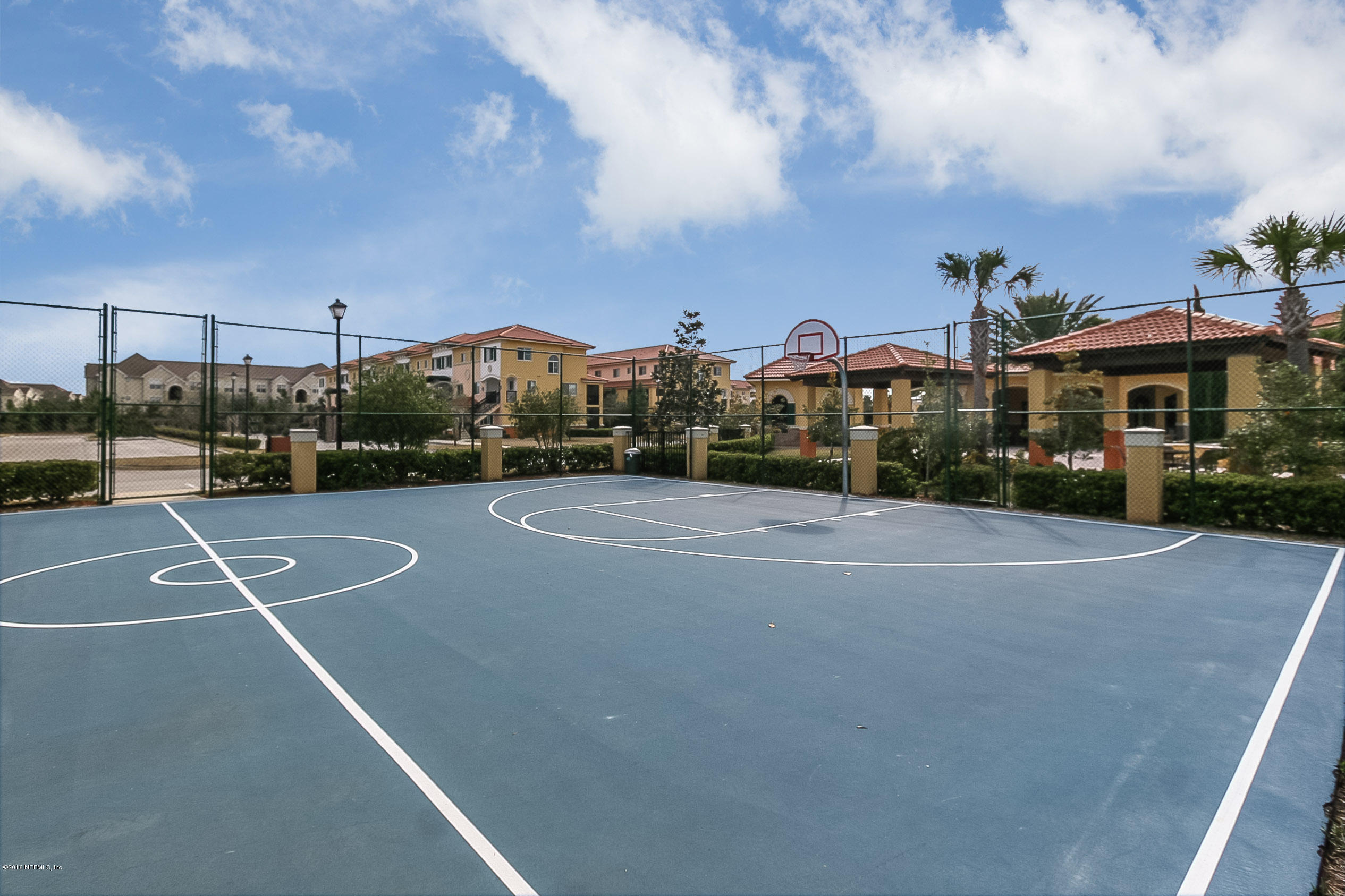 9745 Touchton Road, Unit 2521 Jacksonville, FL 32246 - Photo 19 of 31 a view of a tennis ground with large trees
