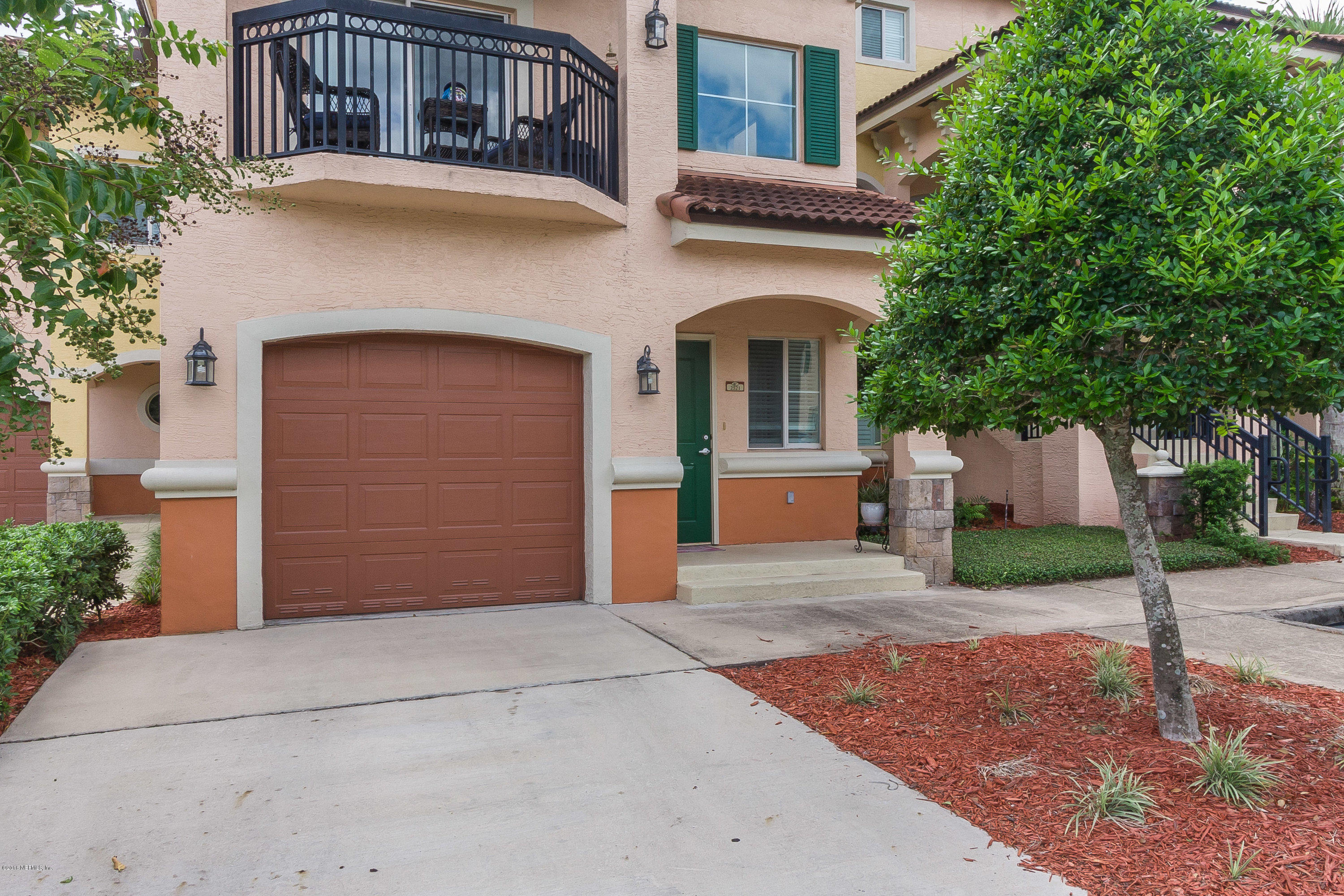9745 Touchton Road, Unit 2521 Jacksonville, FL 32246 - Photo 30 of 31 a front view of a house with a yard and garage