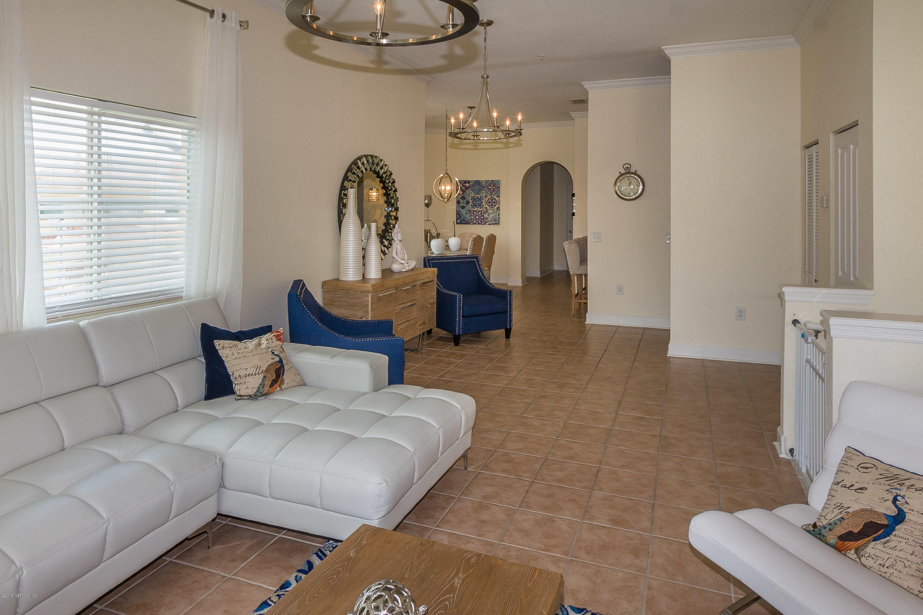 9745 Touchton Road, Unit 2521 Jacksonville, FL 32246 - Photo 5 of 31 a living room with furniture and a chandelier