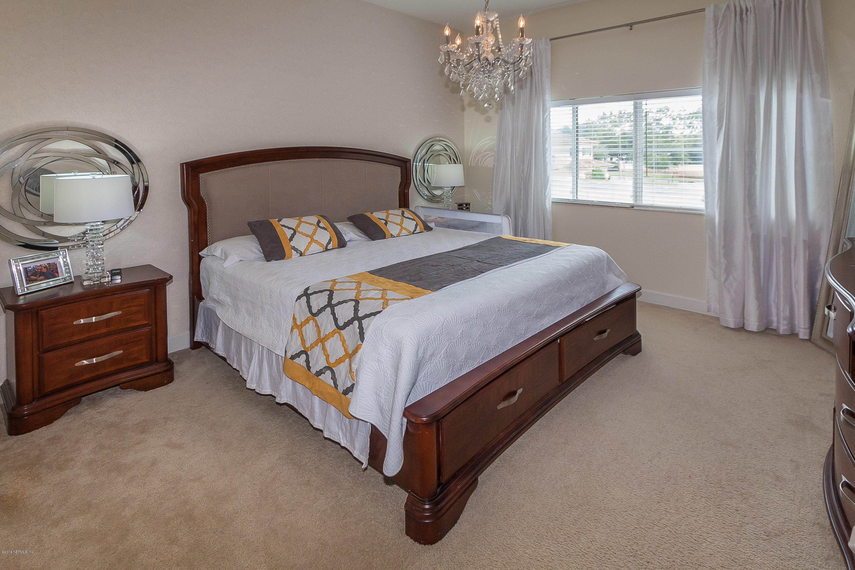 9745 Touchton Road, Unit 2521 Jacksonville, FL 32246 - Photo 10 of 31 a bed sitting in a bedroom next to a window