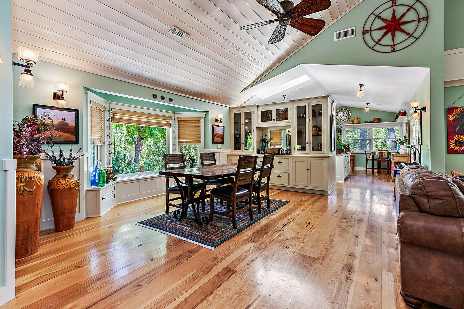 281 Rossier Lane Grants Pass, OR 97527 - Photo 20 of 63 a dining room with wooden floor furniture and a floor to ceiling window