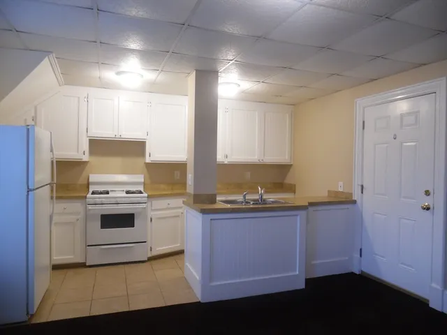 a kitchen with stainless steel appliances a stove a sink and a refrigerator