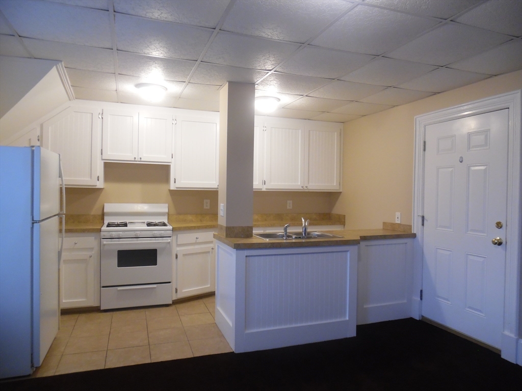 a kitchen with stainless steel appliances a stove a sink and a refrigerator