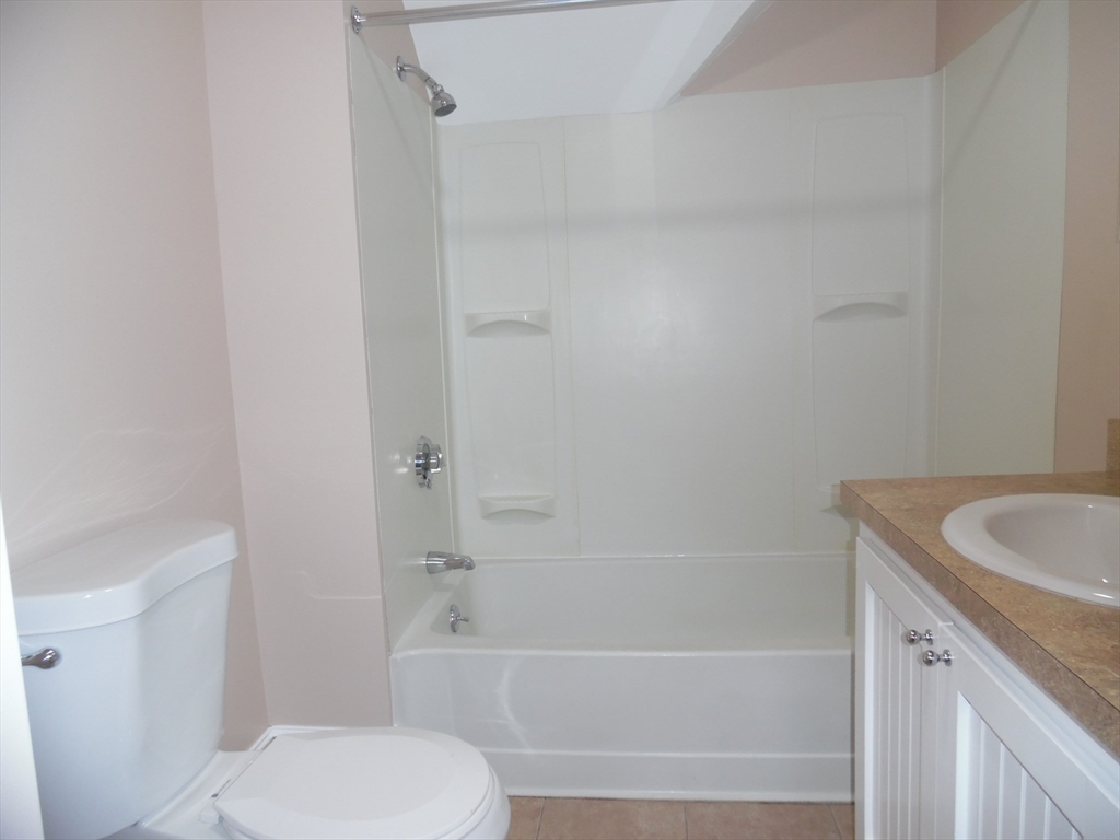 1199 Rodman Street, Unit 3 Fall River, MA 02721 - Photo 2 of 8 a bathroom with a sink and a bathtub
