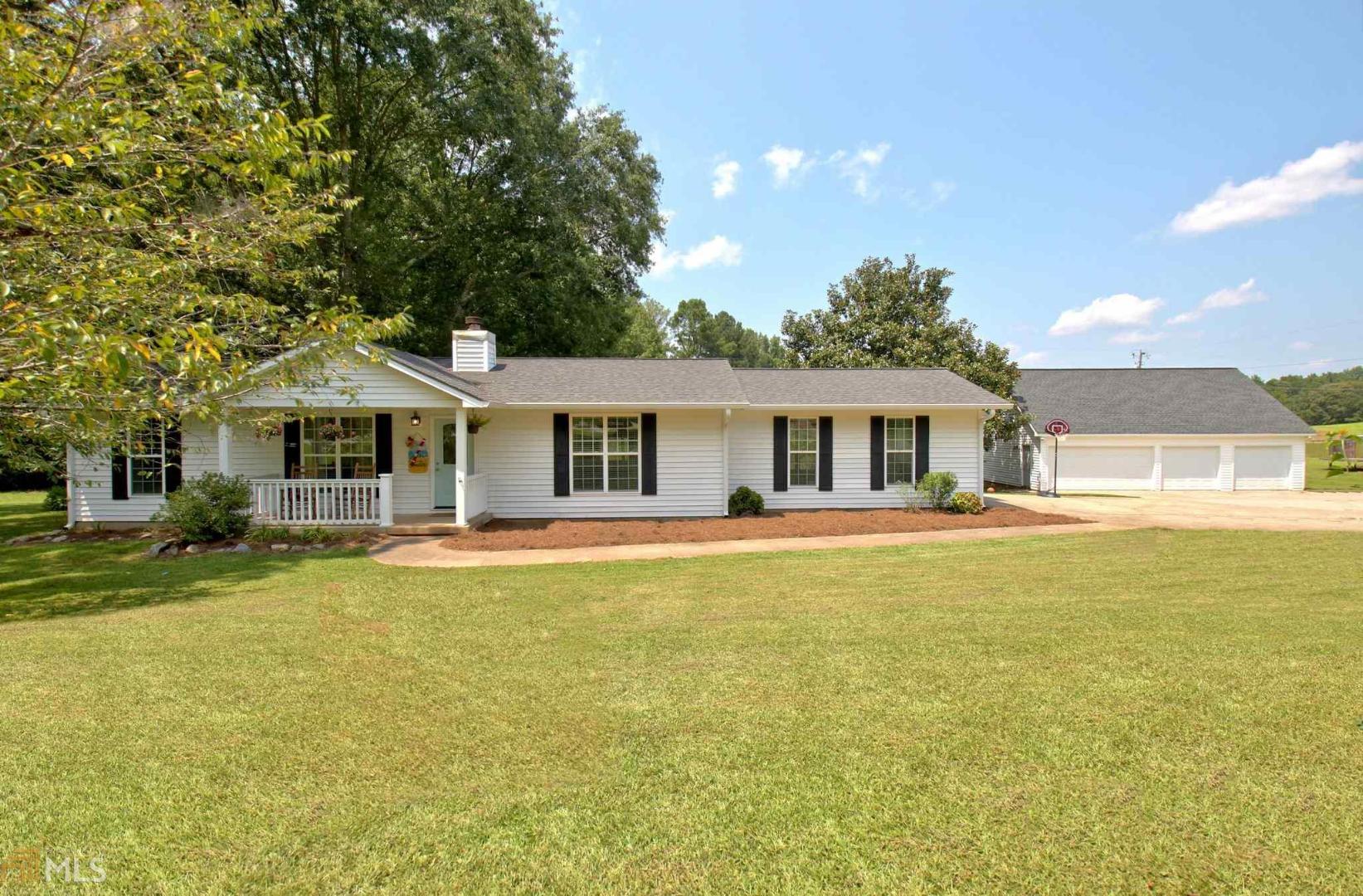 a front view of house with yard and swimming pool