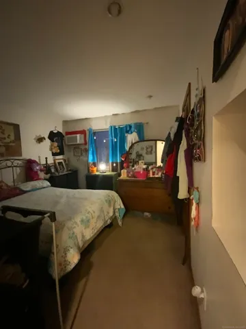 a bed room with a bed mirror and a lamp