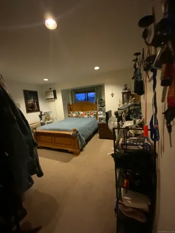 a bedroom with furniture a chandelier and a window