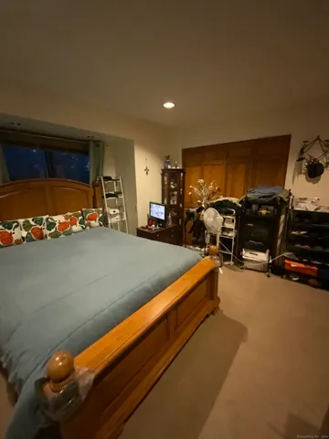 a living room with furniture a flat screen tv and gym equipment
