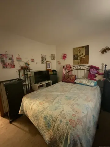 a bedroom with a bed and a lamp