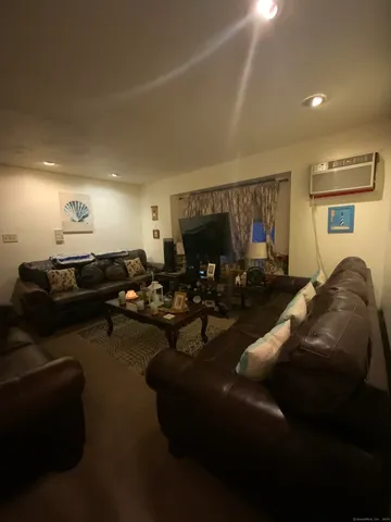 a living room with furniture a rug and a window