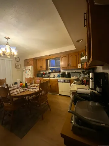 a room with lots of chairs and a chandelier