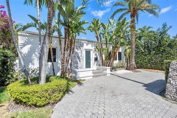 front view of a house with a tree