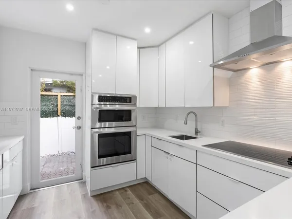a kitchen with a sink stove and cabinets