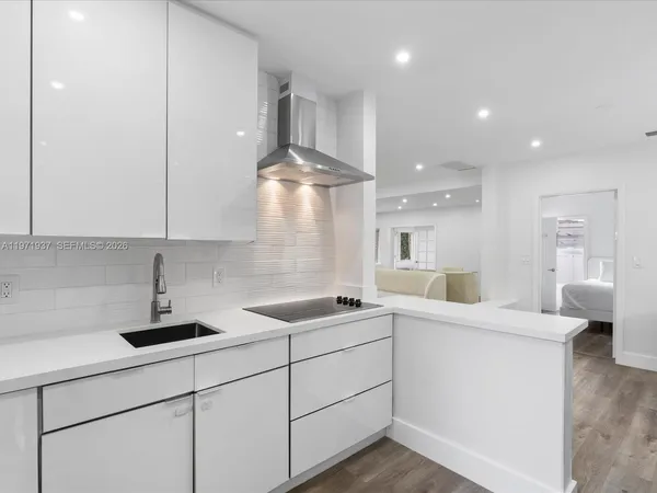a kitchen with stainless steel appliances a sink a stove and a refrigerator