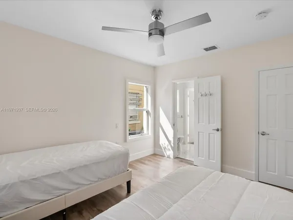 a spacious bedroom with a bed and a window