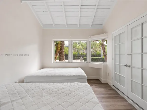 a bedroom with a large bed and a large window