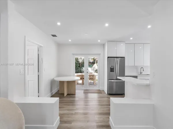 a view of kitchen with refrigerator microwave and cabinets