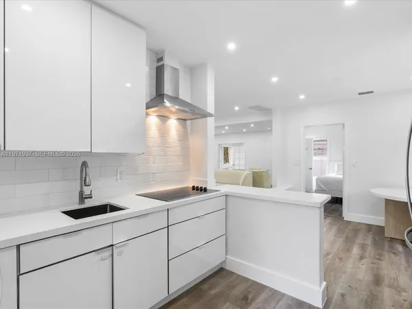 a kitchen with a sink a stove and cabinets