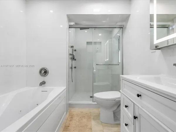 a bathroom with a bathtub toilet and sink