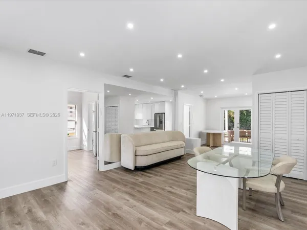 a living room with furniture and a wooden floor