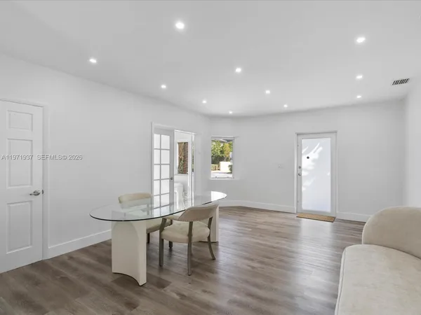 a view of a work space with furniture and wooden floor