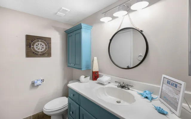 a kitchen with granite countertop a white stove refrigerator and white cabinets with wooden floor