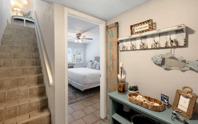 a spacious bedroom with a bed and a flat screen tv