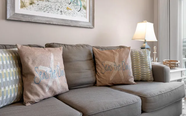 a living room with furniture and a lamp