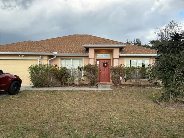 a front view of a house with a garden and plants