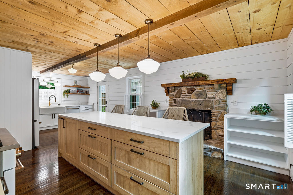 17 Florida Road East Haddam, CT 06423 - Photo 11 of 40 Designed for entertaining, the spacious kitchen island offers plenty of room to gather in front of the charming stone fireplace.