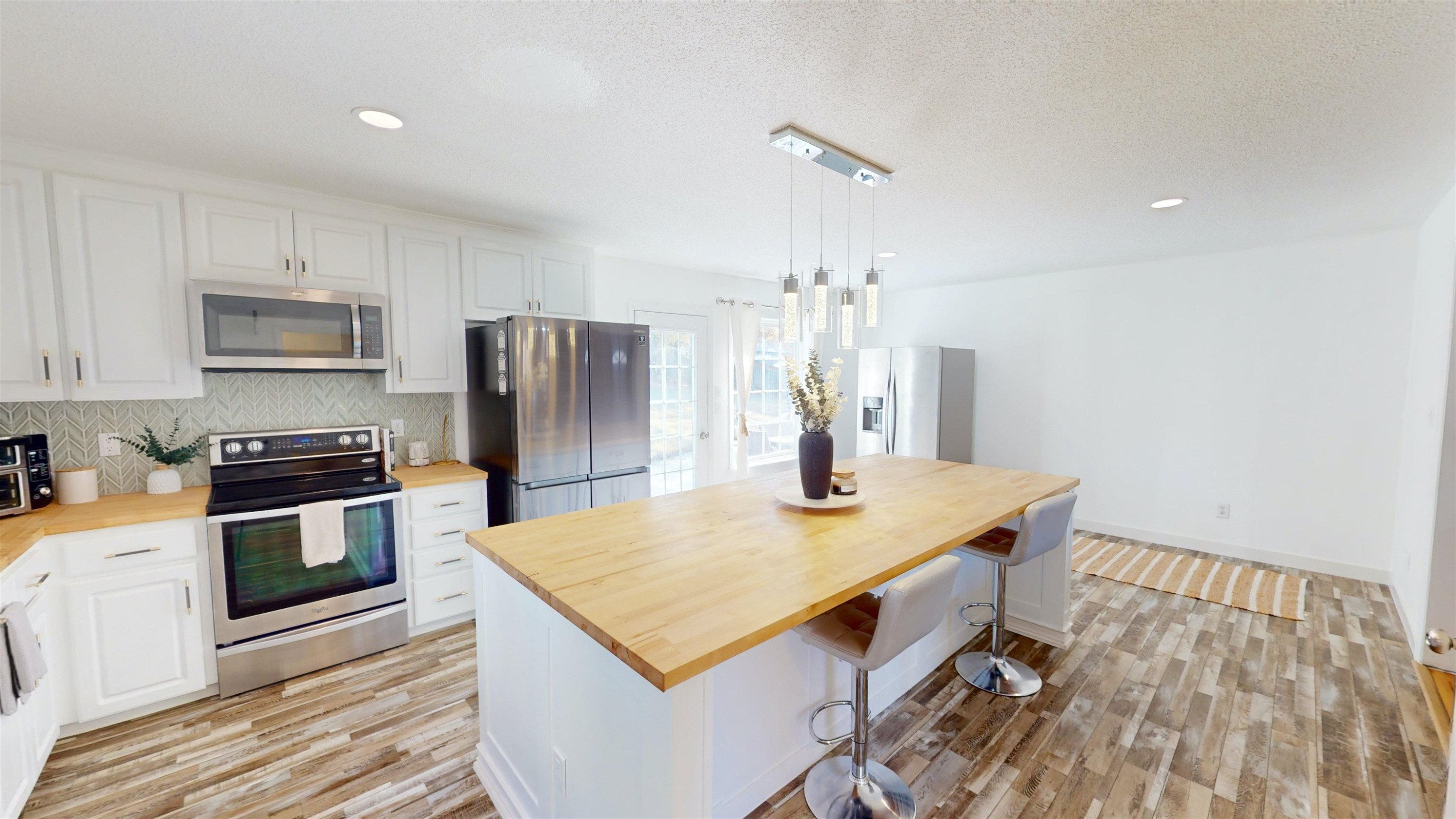 1036 Drew Drive Garner, NC 27529 - Photo 14 of 59 a kitchen with kitchen island a sink dishwasher a stove and a refrigerator with wooden floor