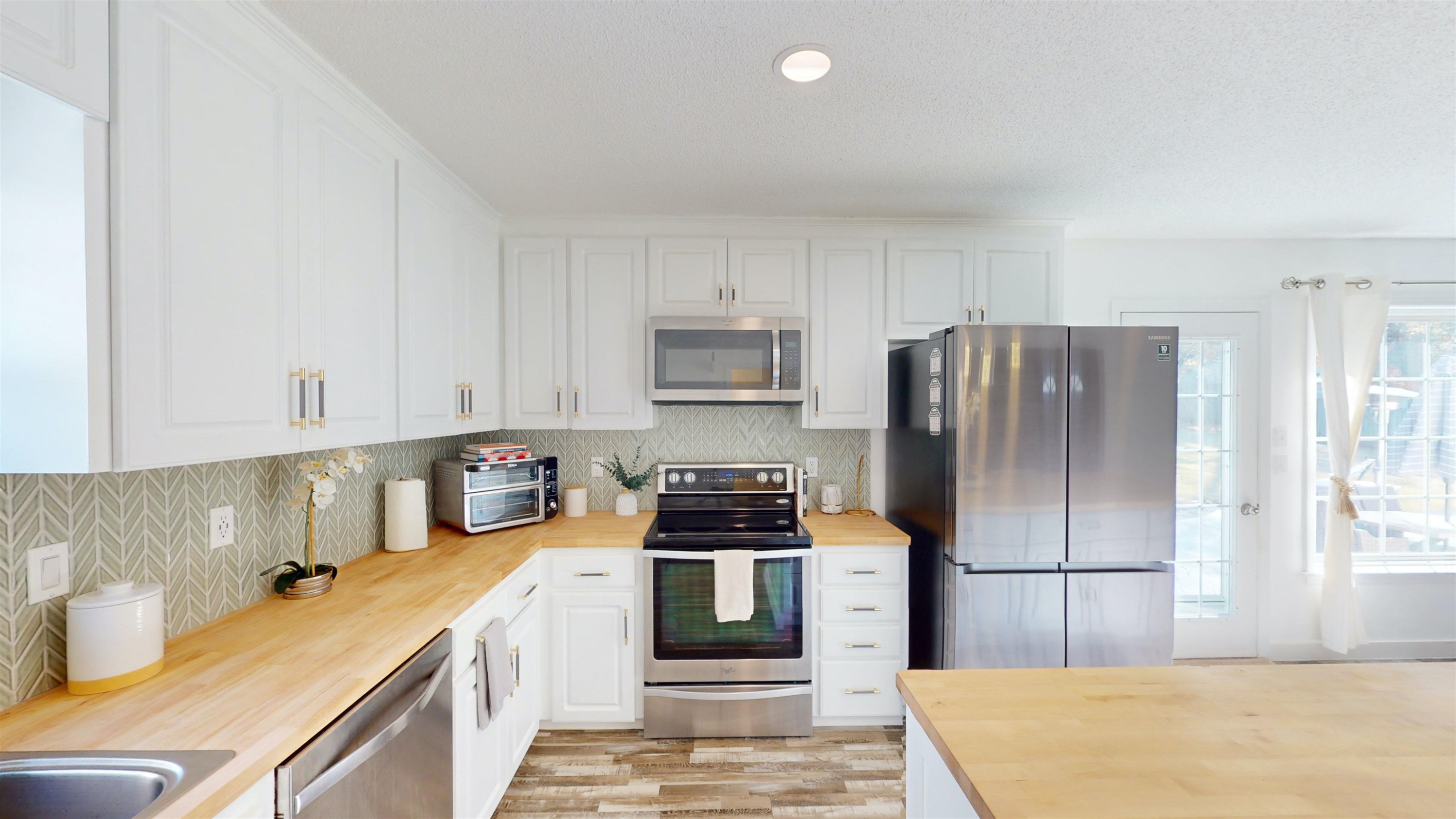 1036 Drew Drive Garner, NC 27529 - Photo 15 of 59 a kitchen with a sink a stove and refrigerator
