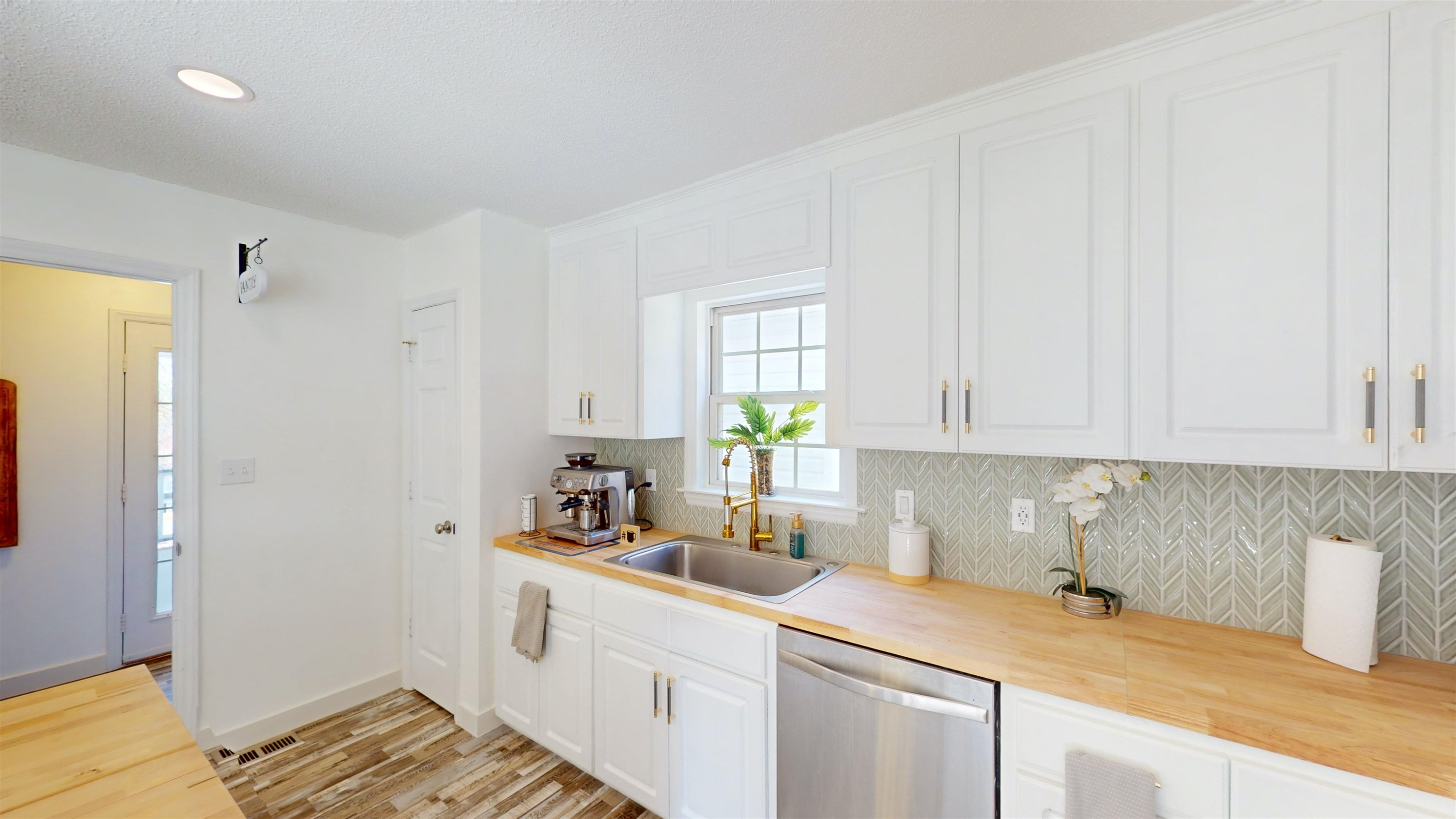 1036 Drew Drive Garner, NC 27529 - Photo 17 of 59 a kitchen with a sink and cabinets