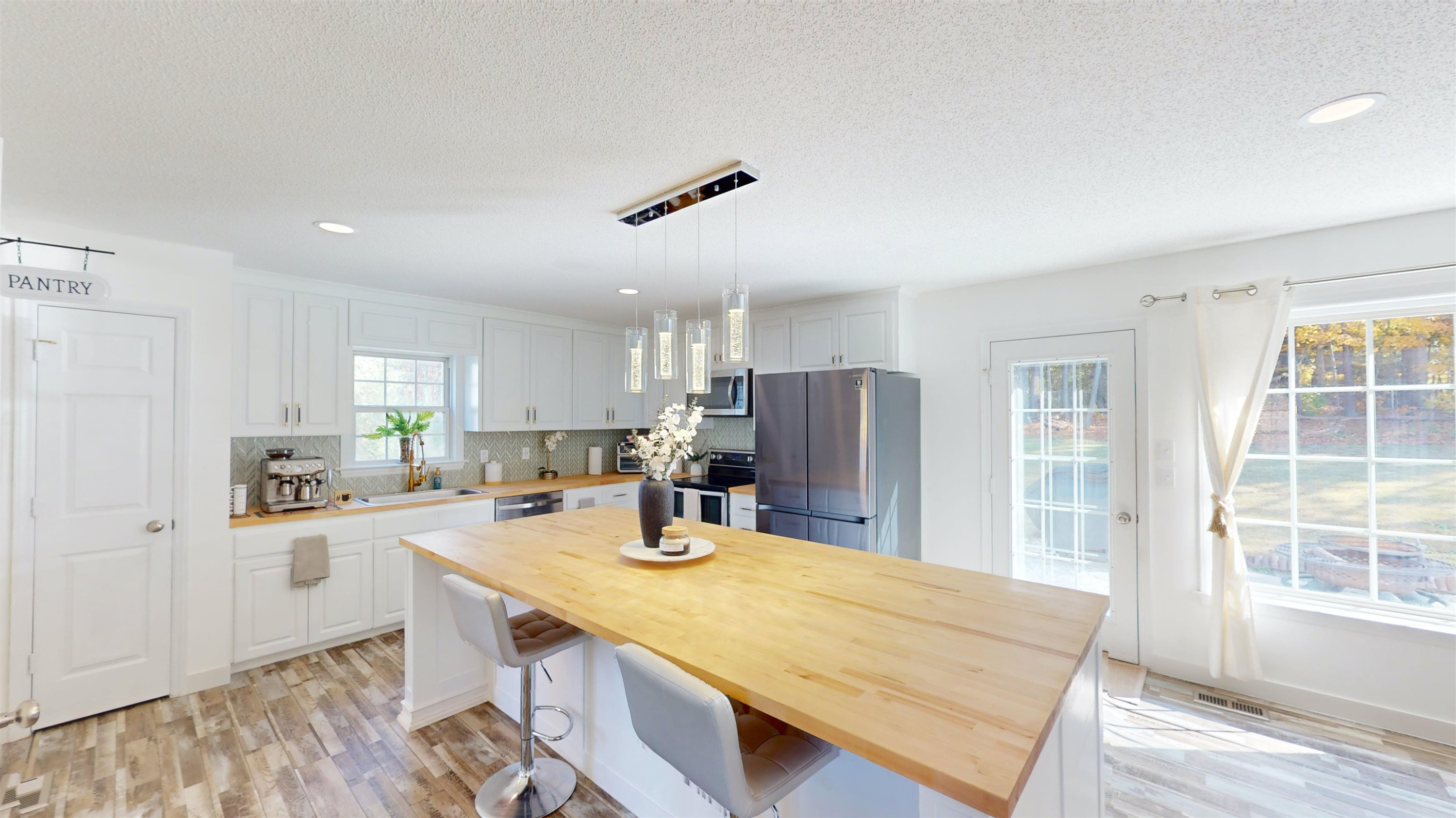 1036 Drew Drive Garner, NC 27529 - Photo 21 of 59 a kitchen with stainless steel appliances granite countertop a sink refrigerator and cabinets