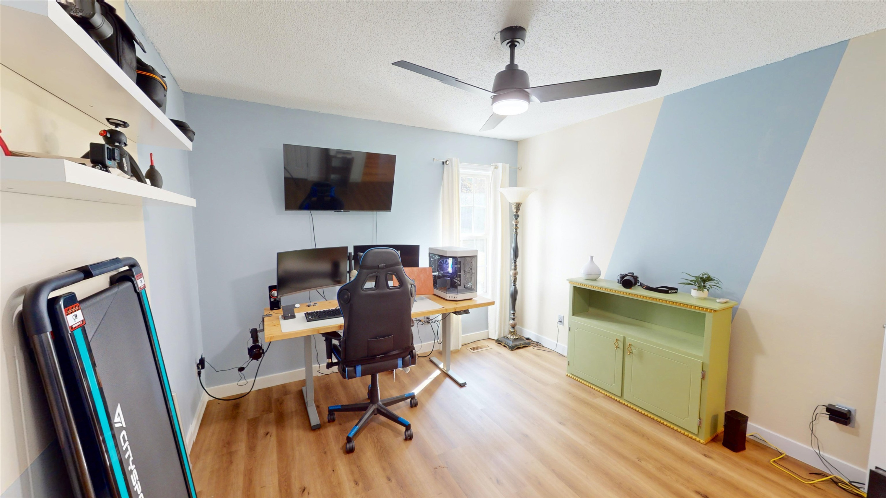 1036 Drew Drive Garner, NC 27529 - Photo 33 of 59 a view of a workspace with furniture and a flat screen tv