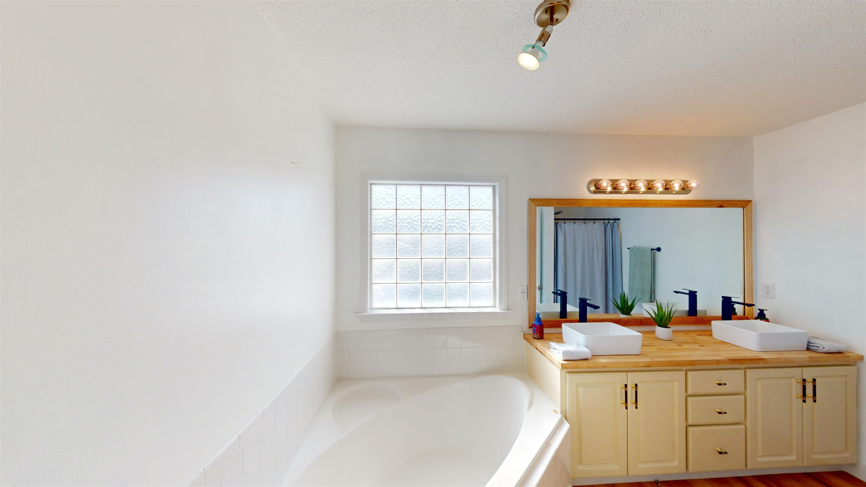 1036 Drew Drive Garner, NC 27529 - Photo 43 of 59 a spacious bathroom with a tub sink and mirror