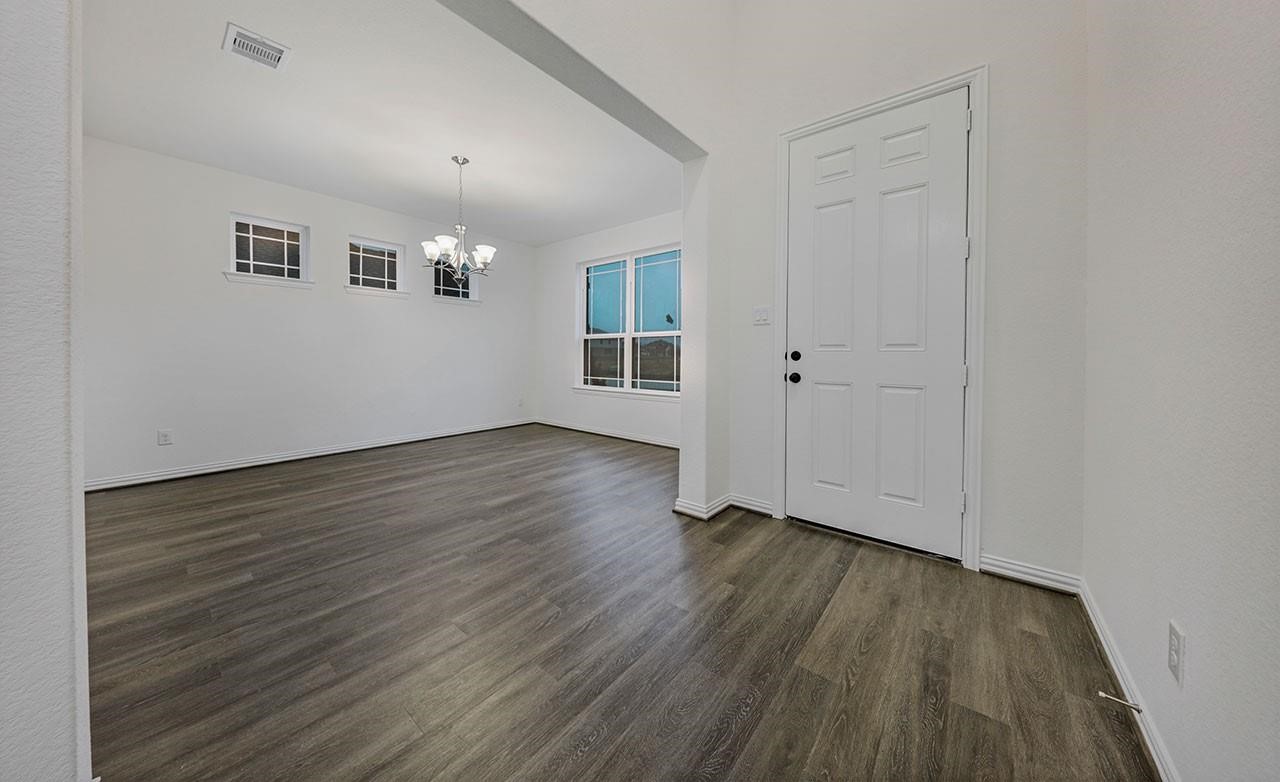 21707 Amalias Drive Hockley, TX 77447 - Photo 5 of 14 a view of an empty room with wooden floor and a window