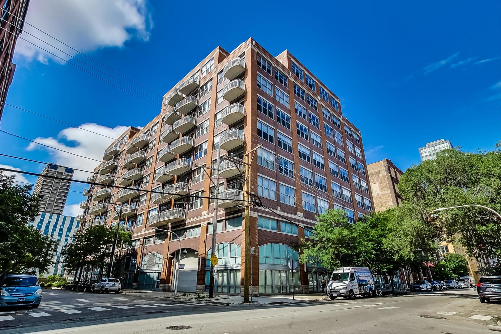 933 West Van Buren Street, Unit 726 Chicago, IL 60607 - Photo 2 of 31 a view of a tall building next to a road