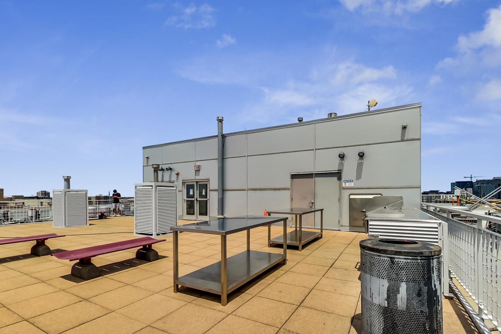 933 West Van Buren Street, Unit 726 Chicago, IL 60607 - Photo 23 of 31 a roof deck with table and chairs