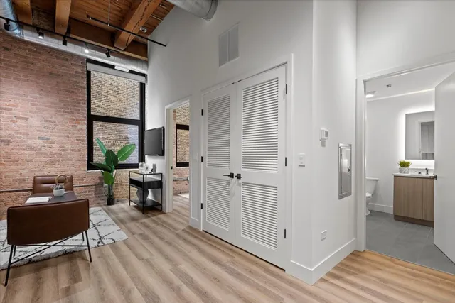 a view of a livingroom with furniture and hardwood floor