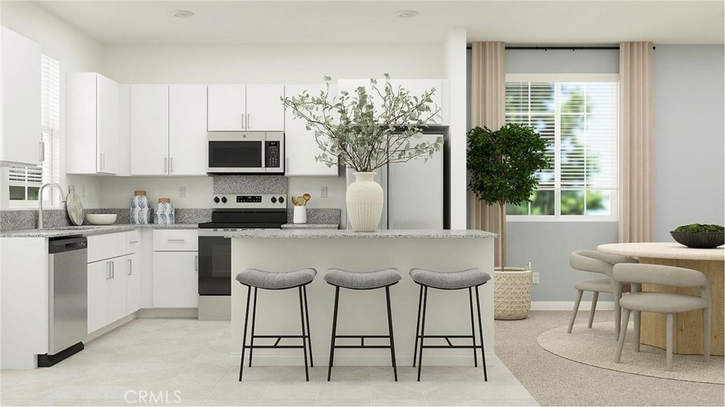 a kitchen with stainless steel appliances granite countertop a stove top oven a sink a dining table and chairs