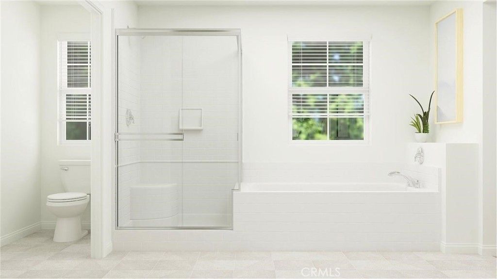 1674 Phantom Lane Rialto, CA 92376 - Photo 14 of 18 a bathroom with a bathtub and a toilet