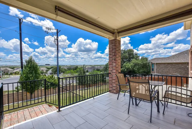 a view of a balcony with furniture
